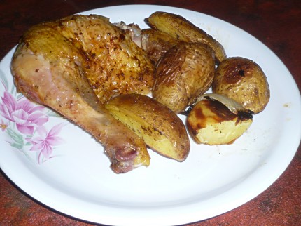 Roast chicken leg and potatoes on a plate