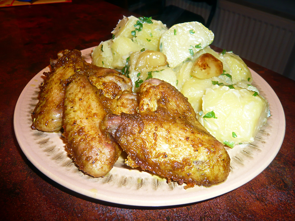 Chicken wings with potatoes on a plate