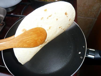 Flipping the tortilla in the pan